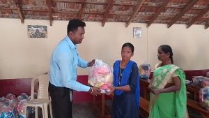 Distributing Sarees and Dry Rations to 50 vulnerable women and men.